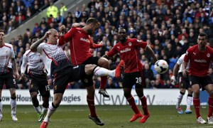 Liverpool's Martin Skrtel, left, scores his team's second against Cardiff City in the Premier League