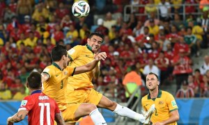 Australia's forward Tim Cahill (C) jumps