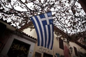 A Greek national flag flutters in the wind at the Plaka district in Athens