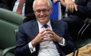 Australian Prime Minister Malcolm Turnbull (centre) reacts during Question Time in the House of Representatives at Parliament House in Canberra, Tuesday, Sept. 15, 2015. Turnbull was sworn in this afternoon after winning the Australian Federal Leadership in a party ballot vote. (AAP Image/Sam Mooy) NO ARCHIVING